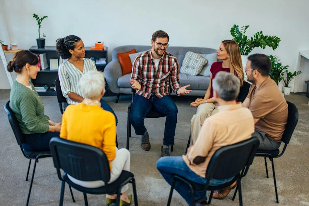 a-man-speaking-up-during-an-aa-meeting