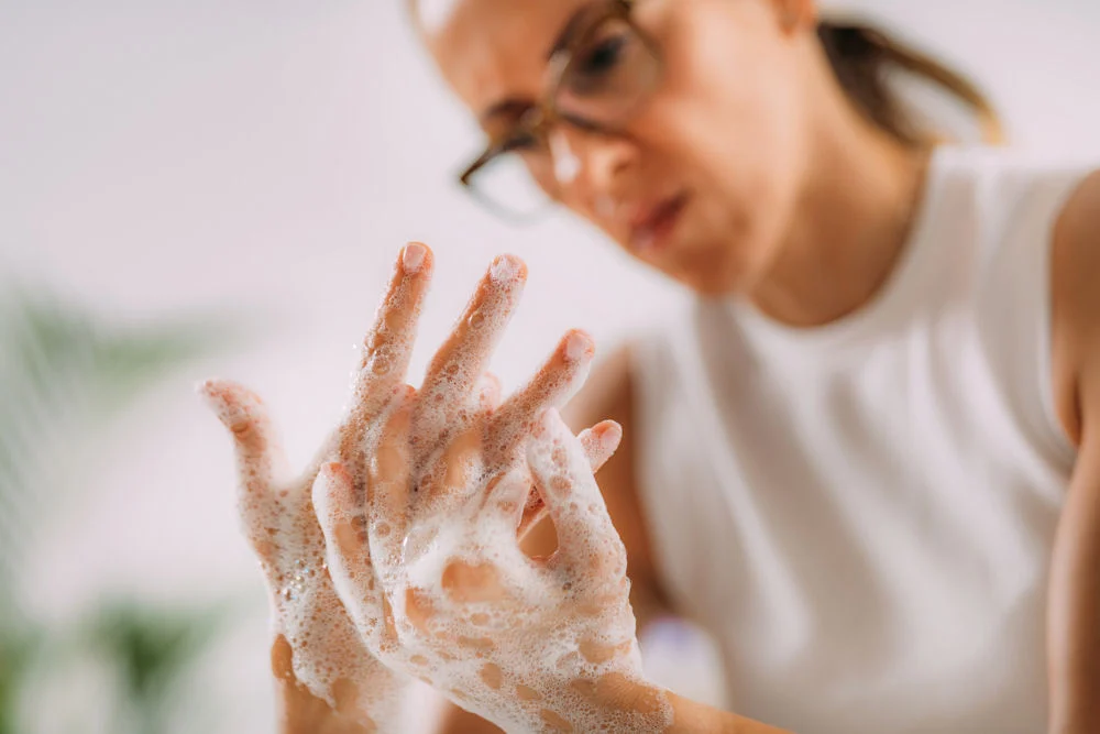 a woman with OCD washing her hands