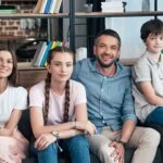 a family smiling in therapy session