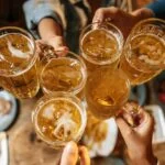 a group of men cheering with beer