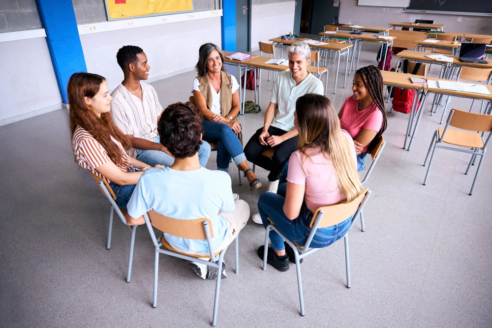 students in a group session discussing tips for staying sober