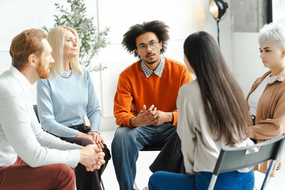 a-group-of-individuals-in-therapy-session a-group-of-individuals-in-therapy-session