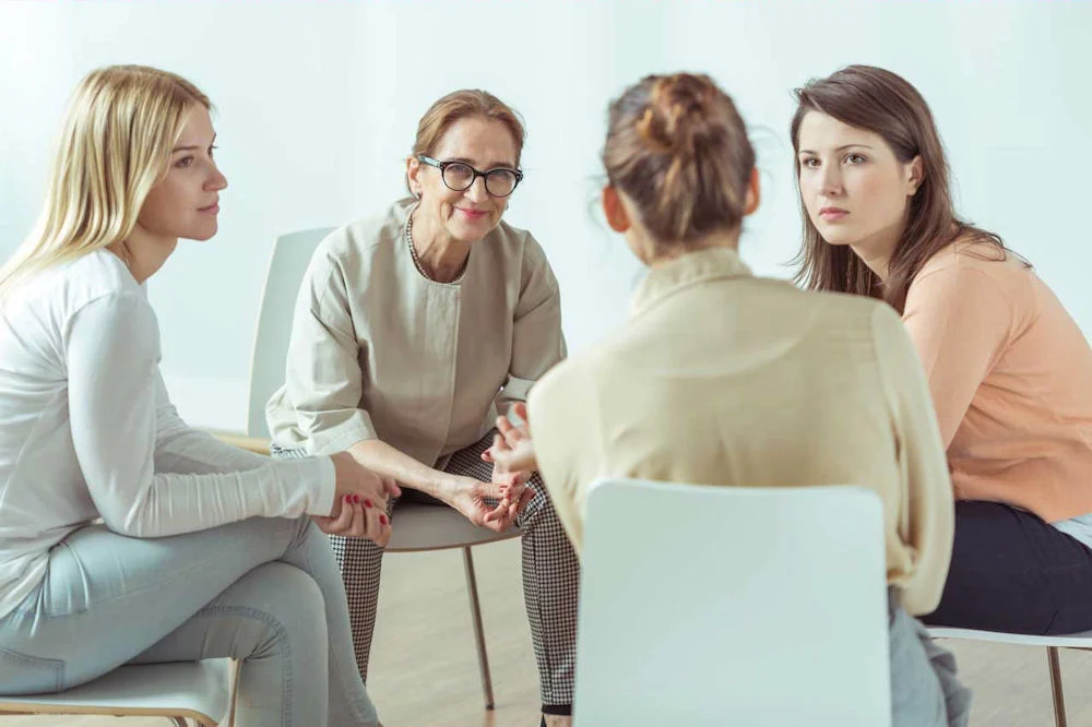 a-group-of-women-in-a-therapy-session a-group-of-women-in-a-therapy-session