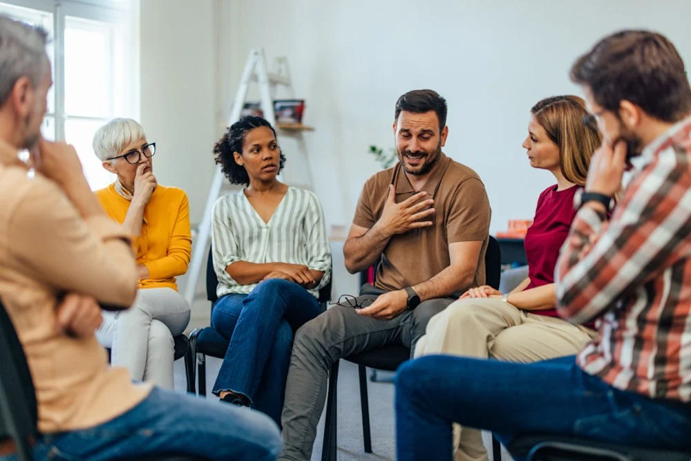 a man speaking in group therapy