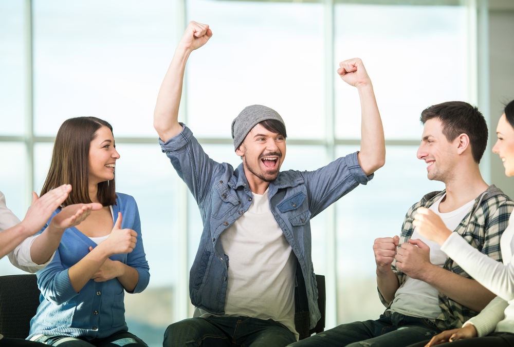 man celebrating his sobriety milestones with his support group