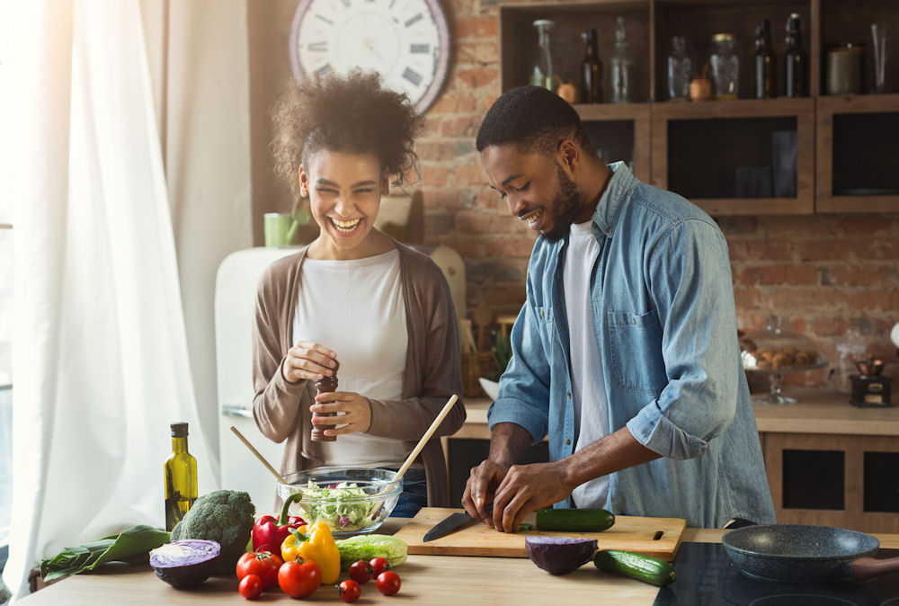 a couple cooking while laughing