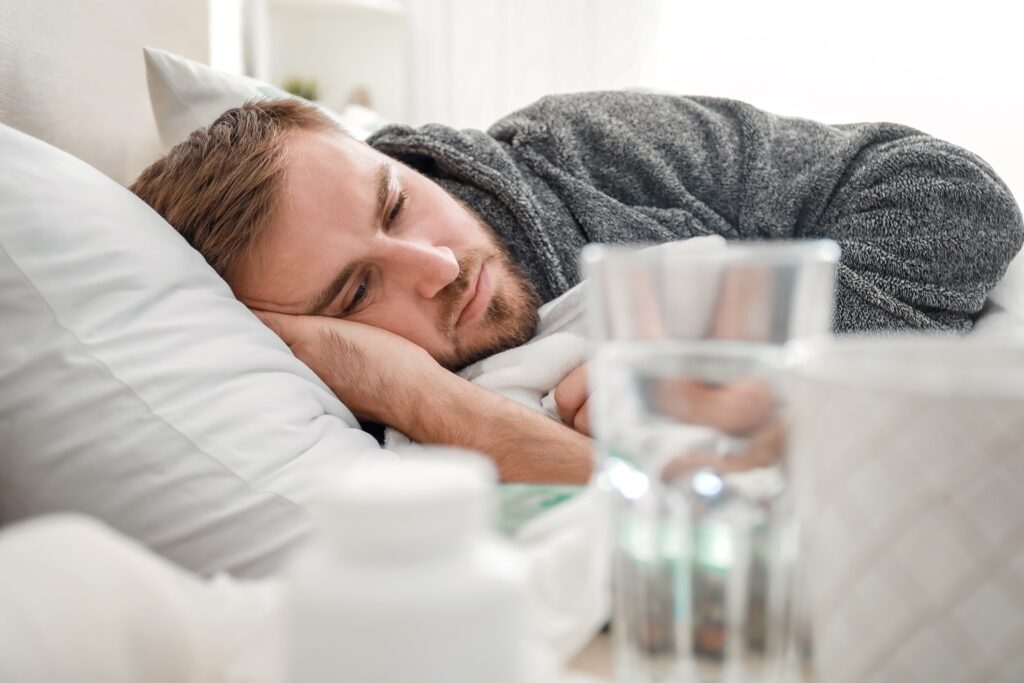 a man laying down after taking pills