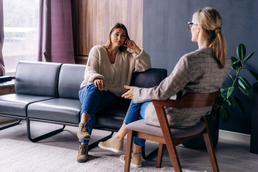 A woman in a therapy session, discussing potential memory issues related to gabapentin use.