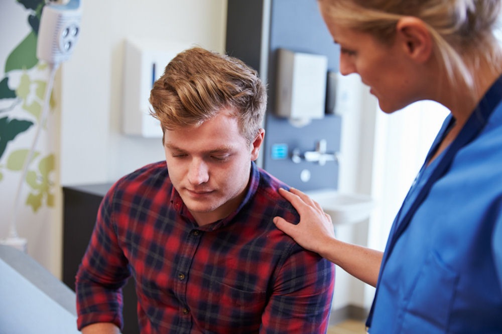 young man at doctor for breathing problems