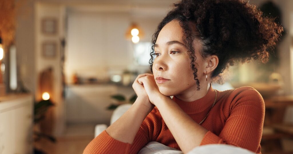 a woman staring out sitting on couch