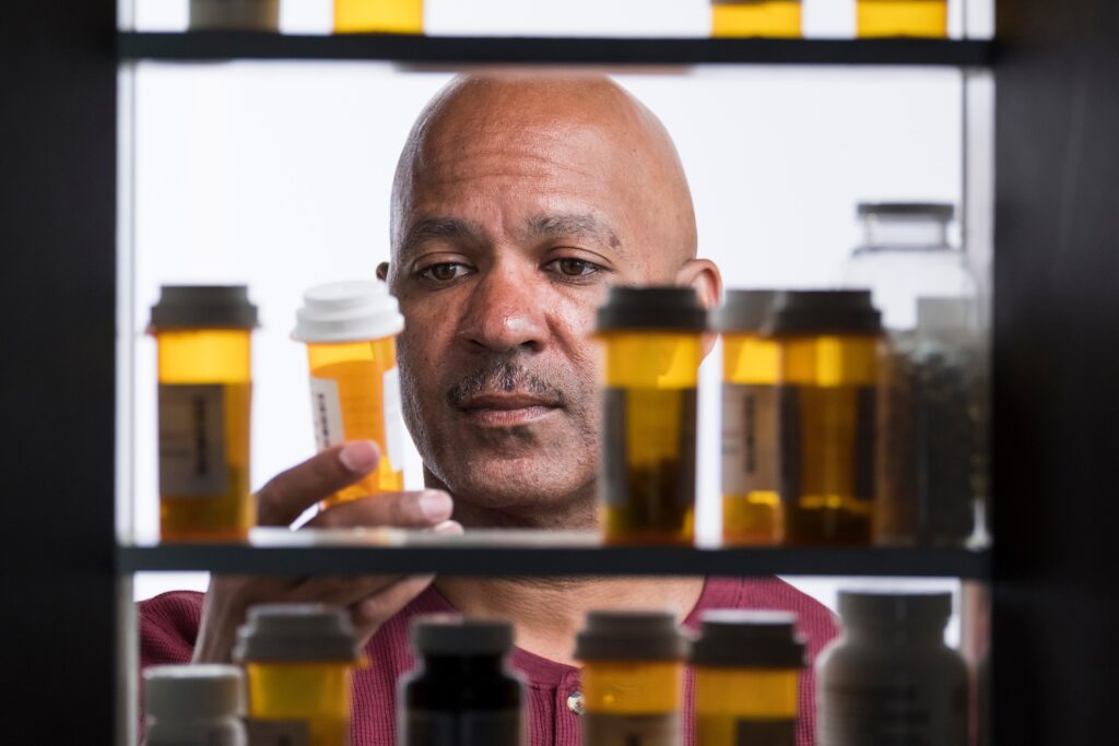 a man looking in a medicine cabinet