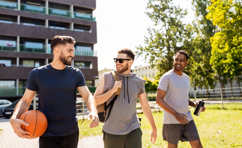 a group of men going to play basketball outside