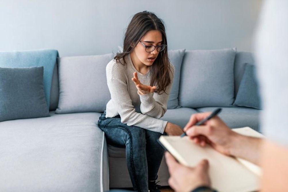 Young woman opening up during a counseling session as part of rehab for Xanax.