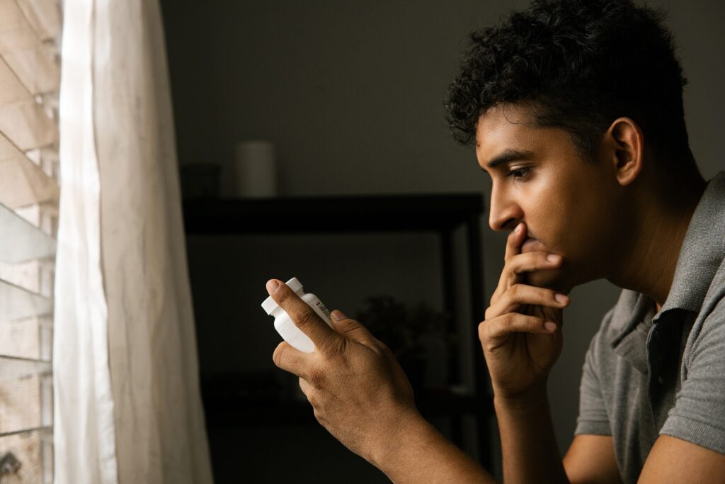 Man feeling overwhelmed while learning how long opioids stay in your system during recovery.
