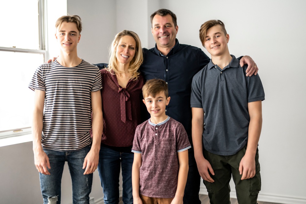 a family smiling standing