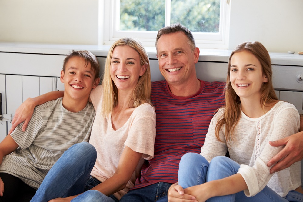 a family smiling sitting