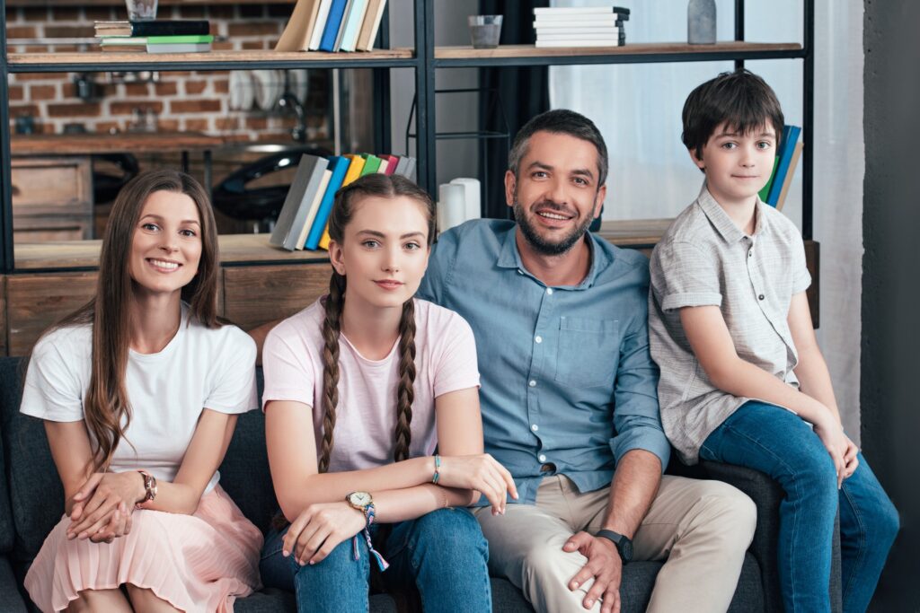 a family smiling in therapy session