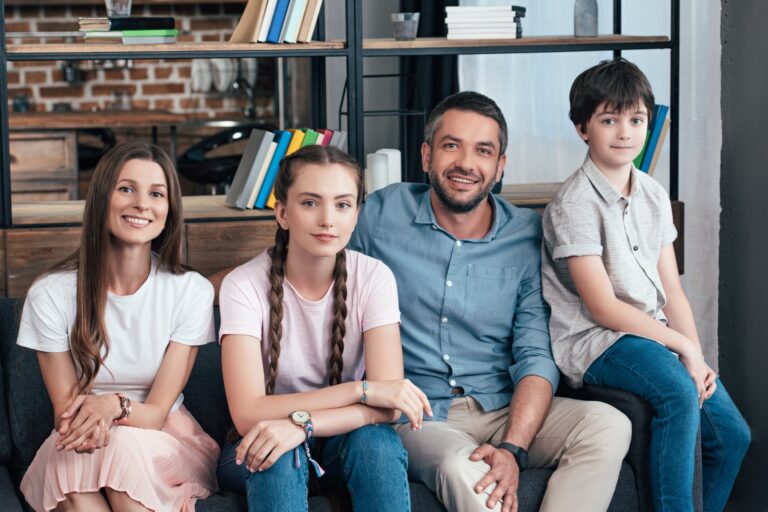 a family smiling in therapy session