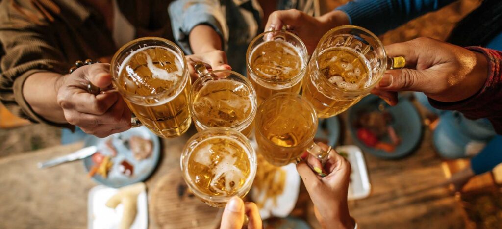 a group of men cheering with beer