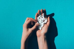 woman holding antidepressant pills to manage and overcome depression